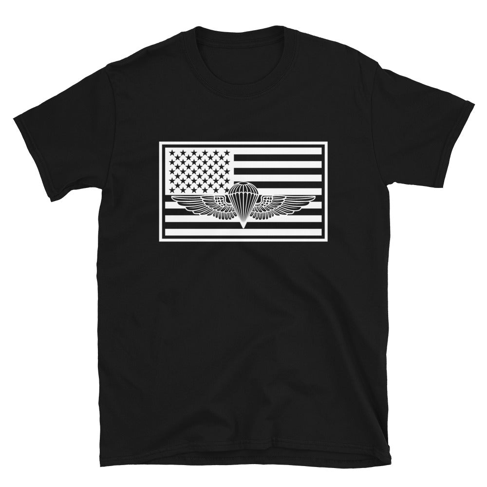 A black short-sleeve unisex T-shirt with a graphic of the US flag containing a white stencil of a naval parachutist.